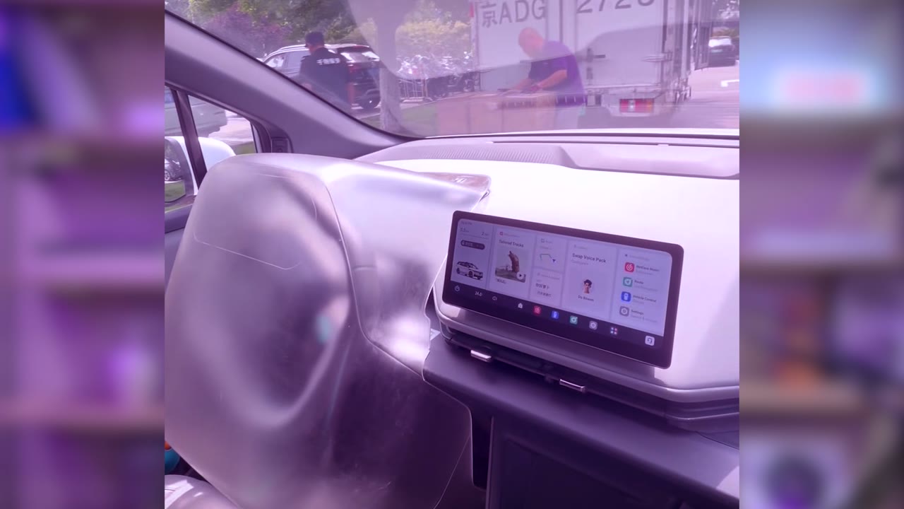 Dashboard screen inside a fully autonomous car in China showing voice assistant and vehicle controls