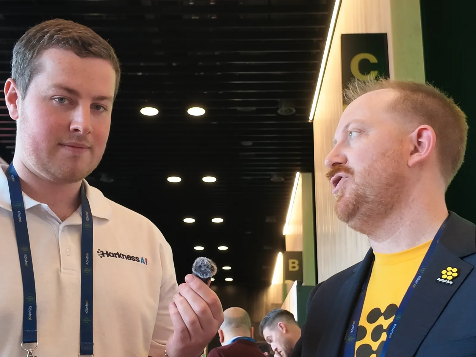 John-Daniel Trask in an Autohive t-shirt and blazer answering a question from Blake Harkness