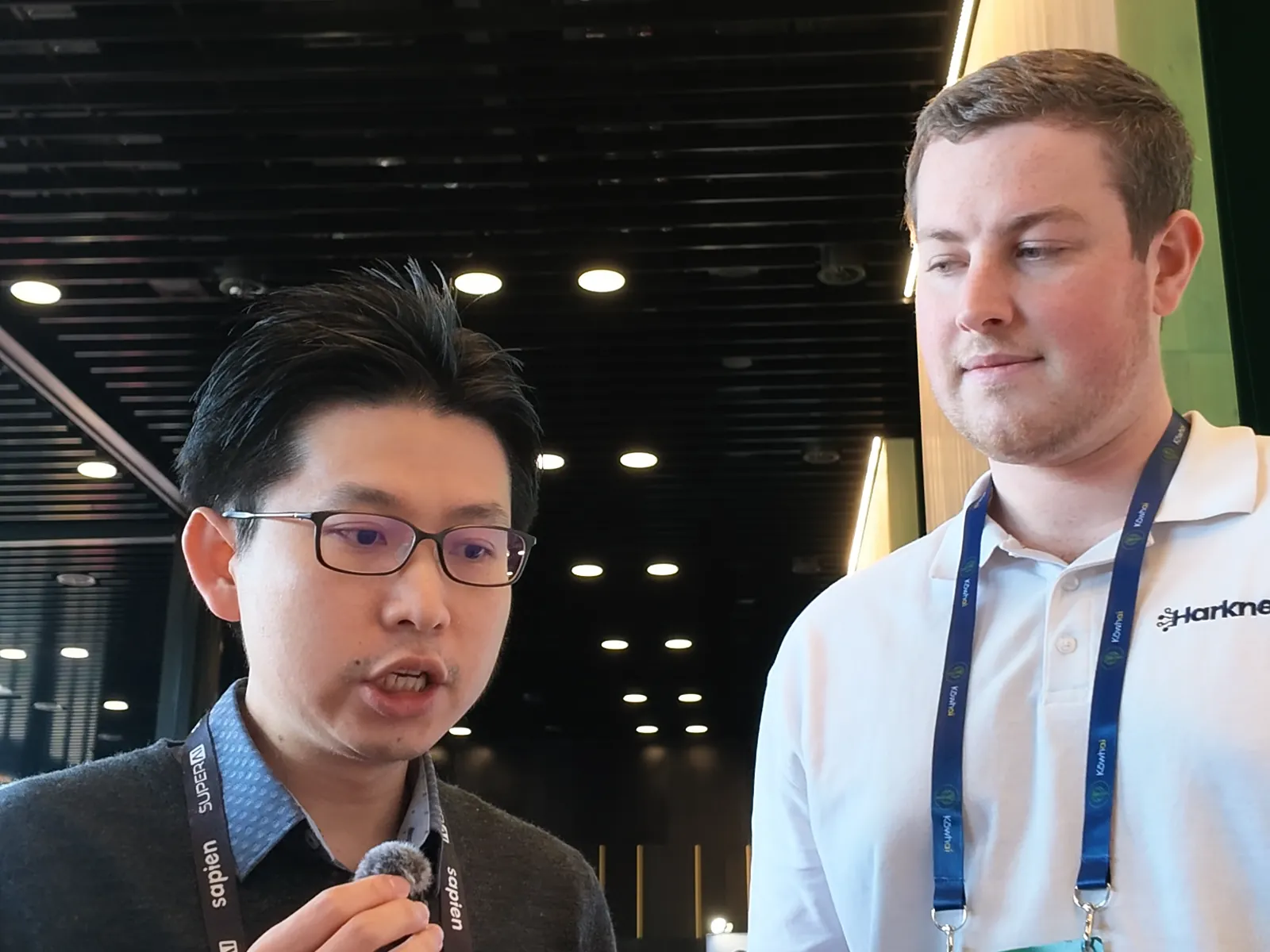 Ming Cheuk answering a question while Blake Harkness listens beside him